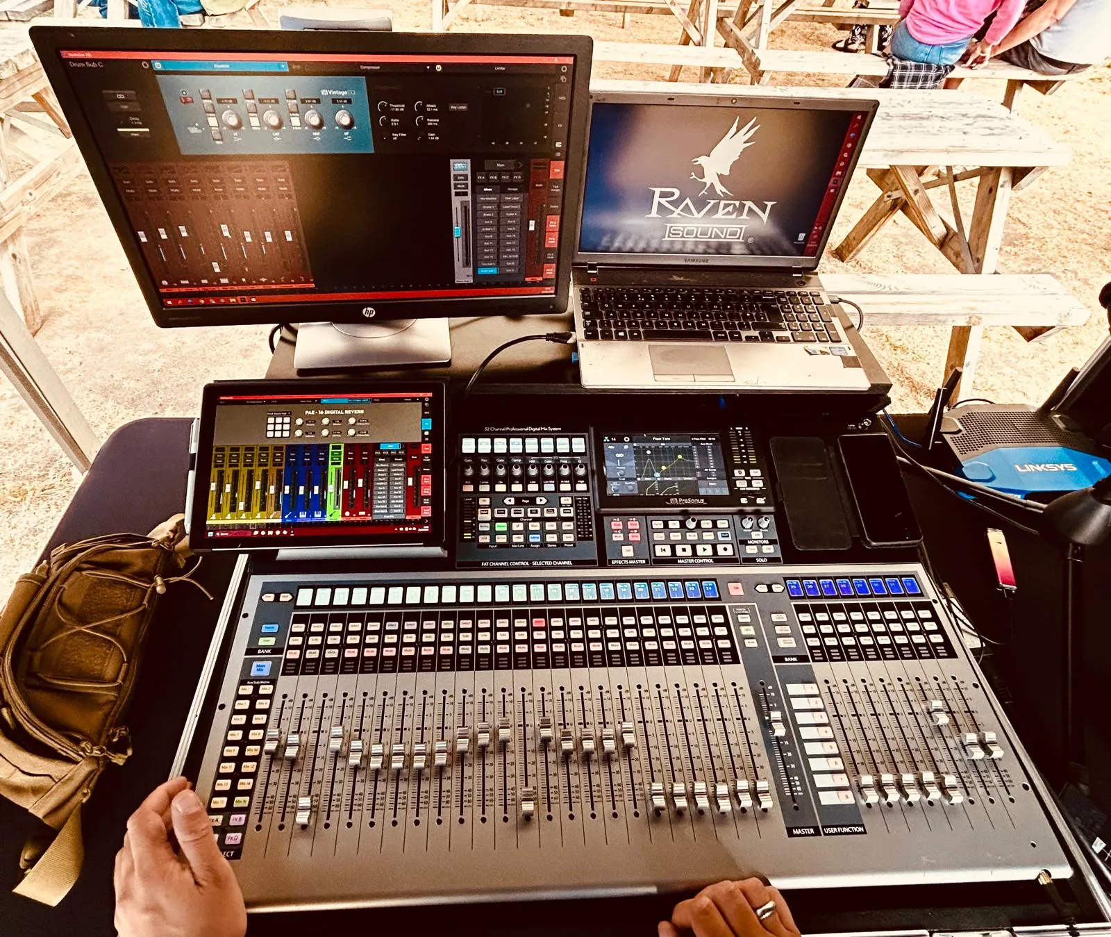 The Raven Sound desk set-up with monitor, laptop and mixer